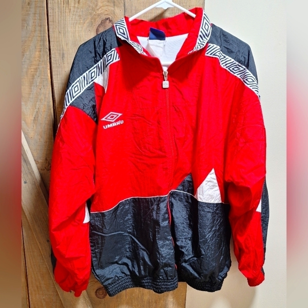 A vintage red Umbro full zipper windbreaker in a mens medium.